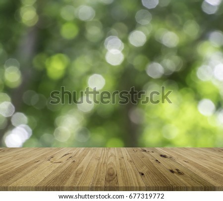 Empty brown wooden table with blurred green nature background, Template mock up for product display