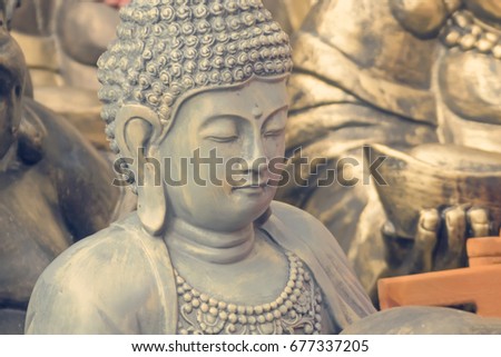Gray Buddha sculpture. Toned