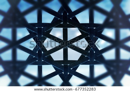 Black wicker lattice on a blue background