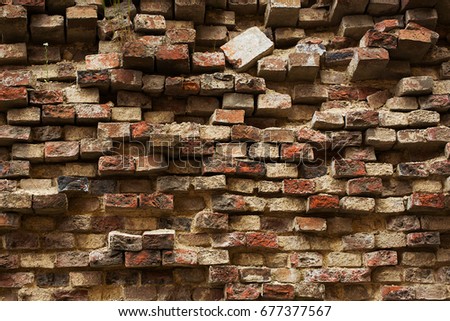 Old wall from it is red also a black brick. Brick background. Texture. Pattern.