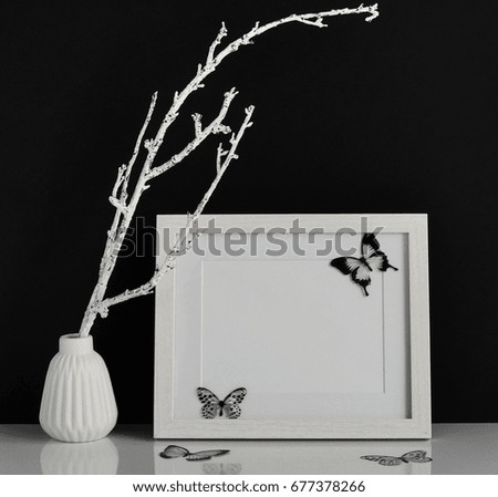 White frame mockup with interior items on black background. Poster product design styled mock-up.Copy space