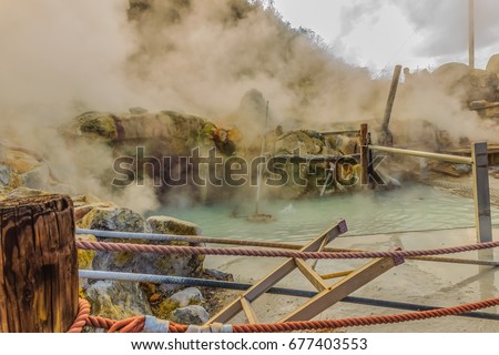 Owakudani hot spring pond with misty and active sulfur vents is popular scenic views, volcano activity and black eggs boiled in hot springs at Hakone, Japan. Royalty-Free Stock Photo #677403553