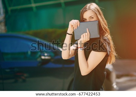 beautiful girl in the city with tablet