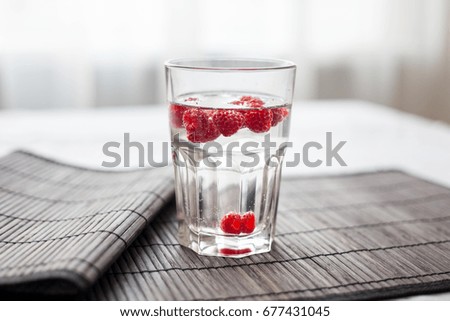 Sparkling raspberry lemonade water in a transparent glass