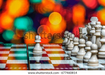 Chess pieces on board with bokeh background