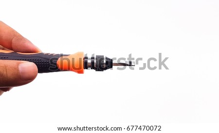 Man's hand holding screw driver with orange color handle isolated