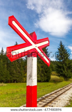 Sign of railroad crossing of a single-track forest railway.