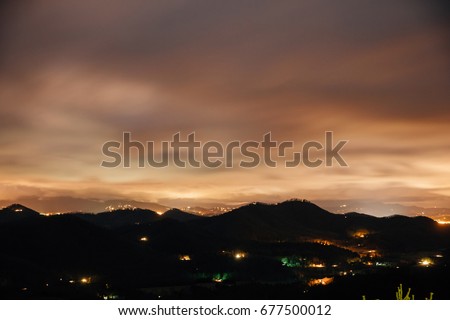 Night time mountainous landscape blurred with lights