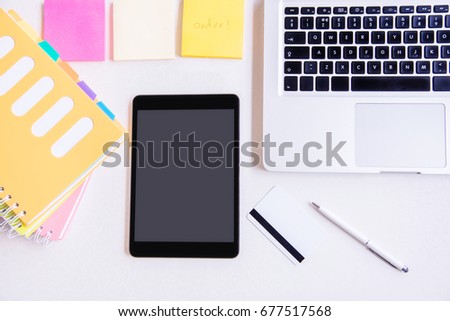 Business working at an office, Modern white office desk table with laptop computer, tablet, credit card and  notebook. Top view with copy space, flat lay.