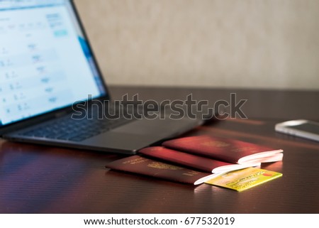 Passports and credit card on laptop and smartphone background. Buy tickets and booking. 