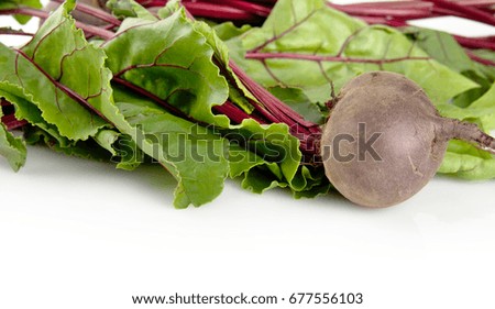 Top view of chard with few beetroots on white background