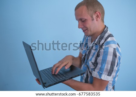 Man in a striped tank top with laptop