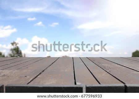 Wood table on blurred sky background,used for display or montage your product