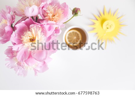 Bouquet of peonies, tea with lemon, sun,  photo in gentle colors. Good morning. Have a nice day! Place for text 