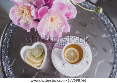 Bouquet of peonies, tea with lemon, photo in gentle colors. Good morning. Have a nice day! Place for text