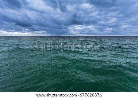 Awesome cloudy sky under the nordic waves lake