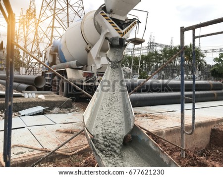 Mixer truck is transport cement to the casting place on building site,Selective focus.Concrete is flowing into the foundations of the building. Royalty-Free Stock Photo #677621230