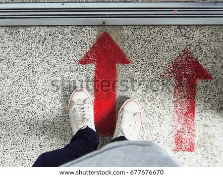 man standing on the move forward sign