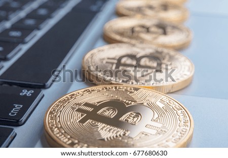 Golden bitcoin on keyboard  background. Close up