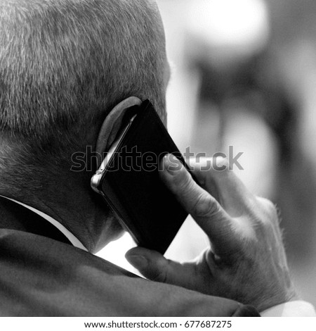 Businessman talking on a mobile phone, rough processing of a black and white photo