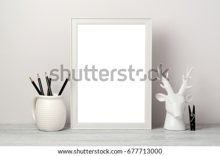 White frame mock up with pencil and decor deer. Modern stylish interior background for social media and marketing.