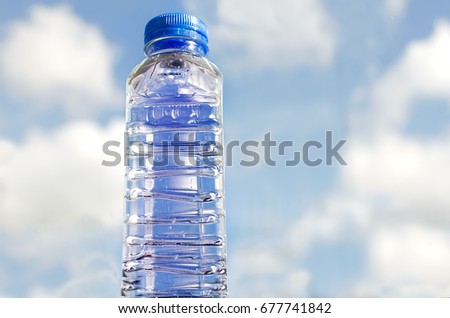 Fresh and clean drinking water in bottle on sky background