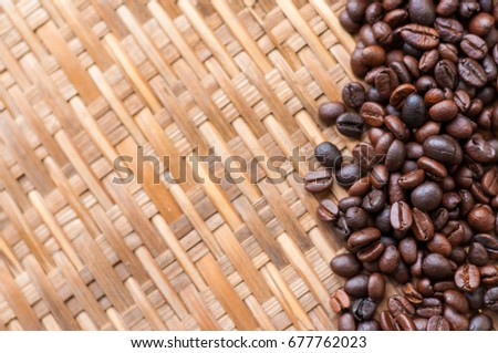 Coffee Beans in white spoon on wooden background