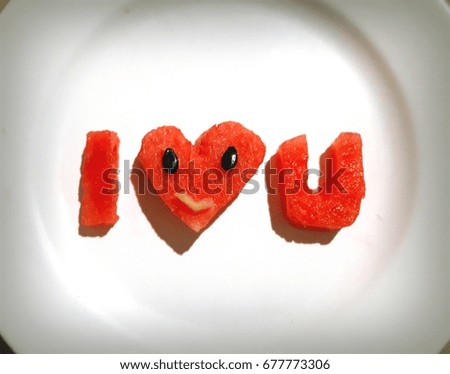 watermelon with the word love lying on the dish