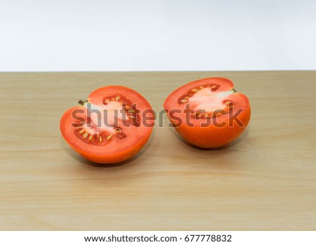 fresh tomatoes on wooden plate.