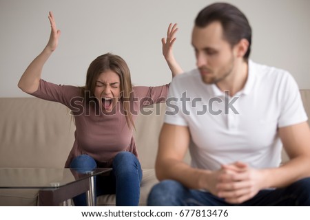 Young woman yelling at boyfriend in hysterics, drama queen screaming loud shouting at husband trying to get attention, having a tantrum, lack of emotional intelligence, manipulation in relationships Royalty-Free Stock Photo #677813476