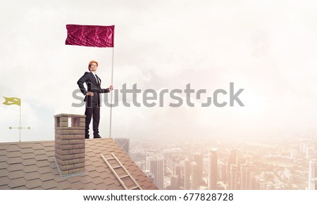 Businessman standing on house roof and red holding flag. Mixed media