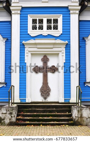 White wooden door with cross on a blue background. Ancient Orthodox Church in Druskininkai, Lithuania.
