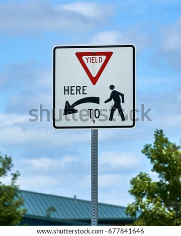 Yield here to pedestrians sign