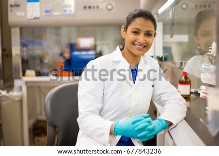 Closeup portrait, scientist posing in front of fume hood, performing laboratory experiments, isolated lab background. Forensics, genetics, microbiology, biochemistry Royalty-Free Stock Photo #677843236