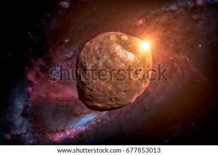 Phobos is the larger and inner of the two natural satellites of Mars, the other being Deimos. Retouched image. Elements of this image furnished by NASA. Royalty-Free Stock Photo #677853013