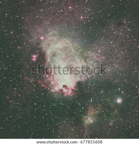 Star-forming region Messier 17, also known as the Omega Nebula or the Swan Nebula. This vast region of gas, dust and hot young stars lies in Milky Way. Elements of this image furnished by NASA.