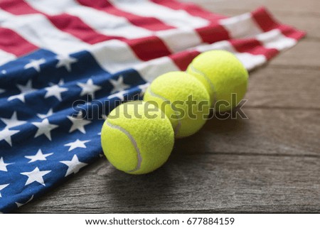 tennis balls with an American flag on wood table