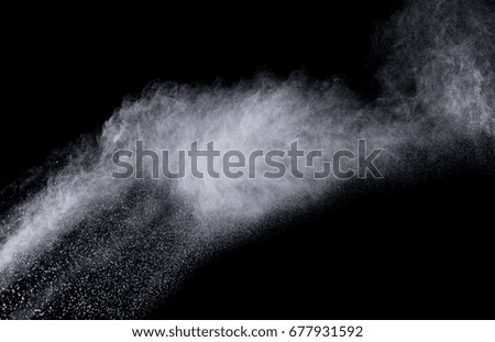 Abstract powder explosion on black background. Colored cloud. White dust explode. Paint Holi.