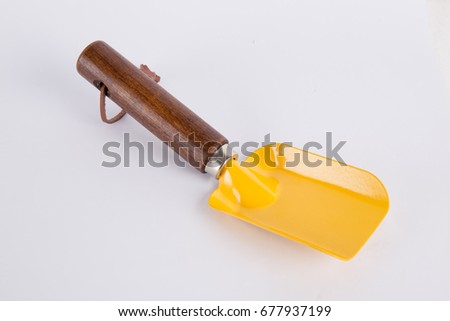 Yellow beach shovel on a white background.