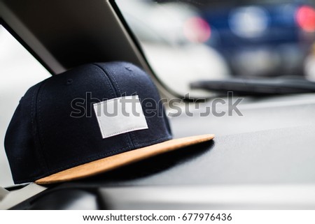 The blue cap in the car with blurry background.