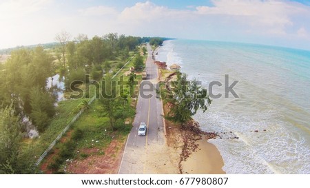 Coastal erosion waves In Southern Thailand . Picture by drone Royalty-Free Stock Photo #677980807