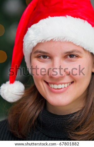 Beautiful girl with red santa hat