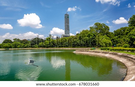Scenic landscape view of Kolkata cityscape with high rise constructions along with Victoria Memorial lake and garden compound.