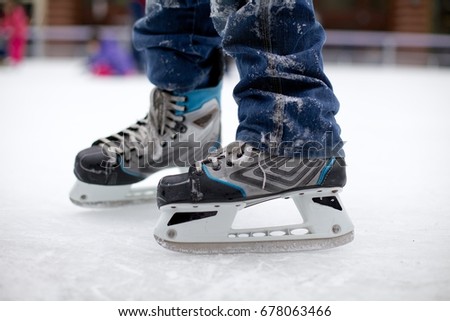 Close up perspective of young boy with ice skates at skating rink