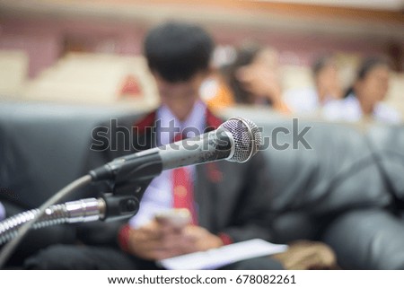 Microphone with blurred background of business person