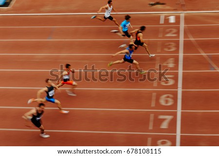 blurred motion finish final sprint of race athlete runners Royalty-Free Stock Photo #678108115