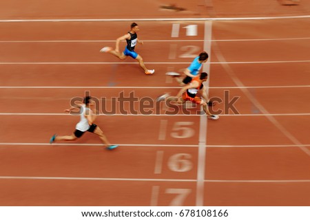 blurred motion sprint finish of race athlete runners Royalty-Free Stock Photo #678108166