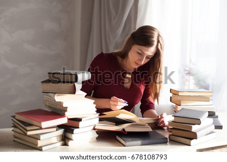 girl reading book prepares for the exam in the library