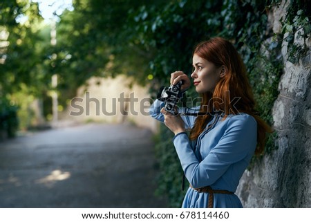 Woman with a camera, taking pictures                               