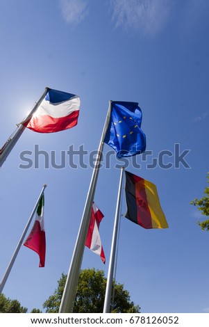 European flags waving against a clear blue sky